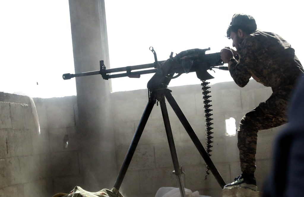 En soldat i den kurdiska YPG-gerillan skjuter mot IS-terrorister i den syriska staden Raqqa. AFP PHOTO / DELIL SOULEIMAN / TT